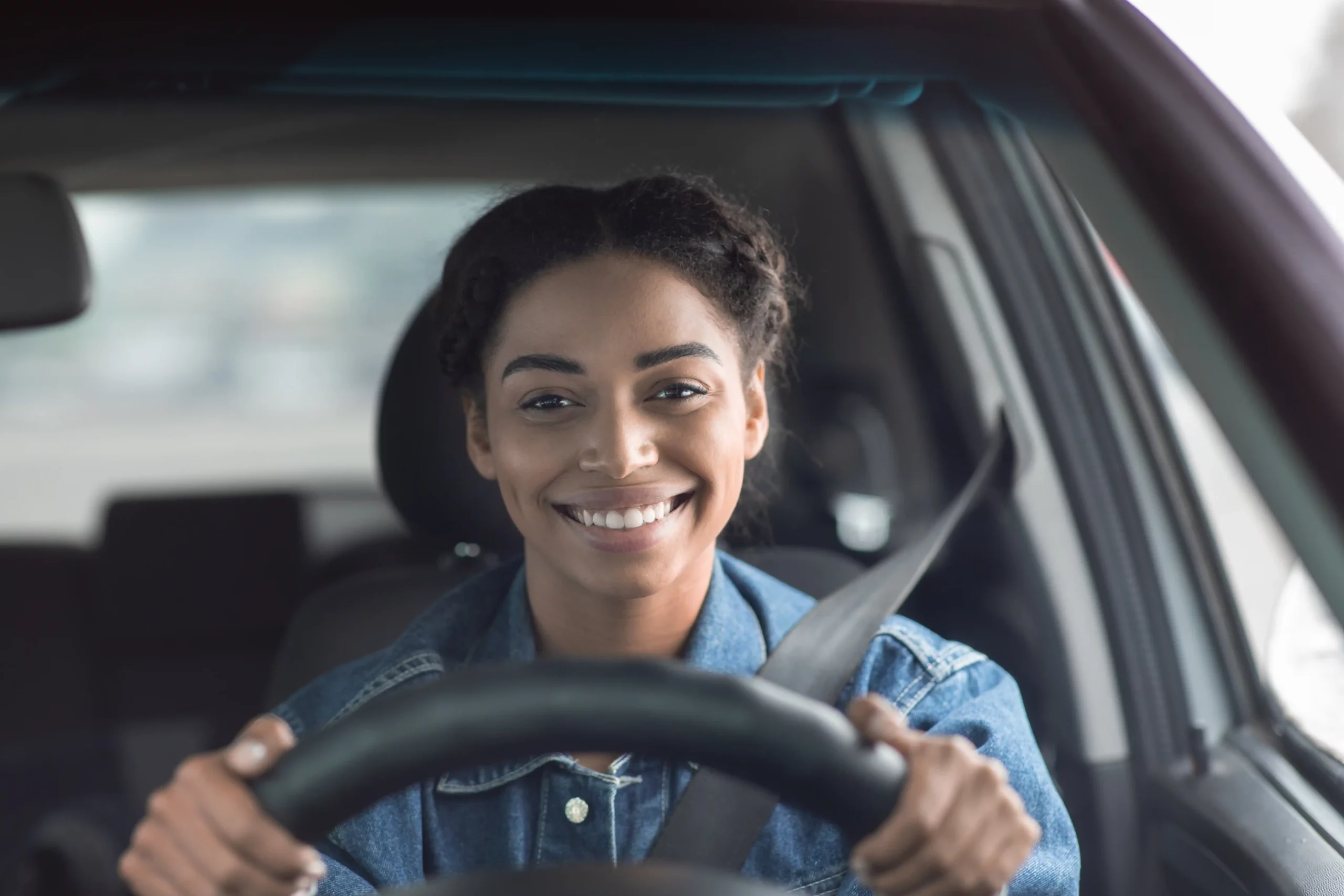 Amazon female delivery driver smiling out of her windshield