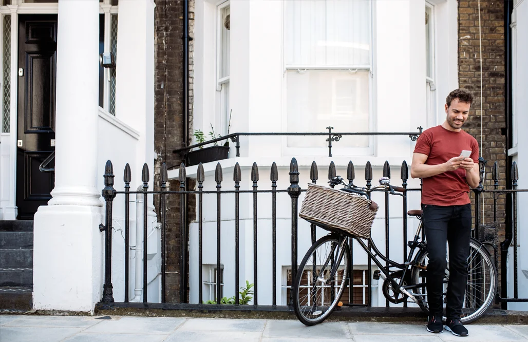 Church of England- Man standing near a vintage bicycle