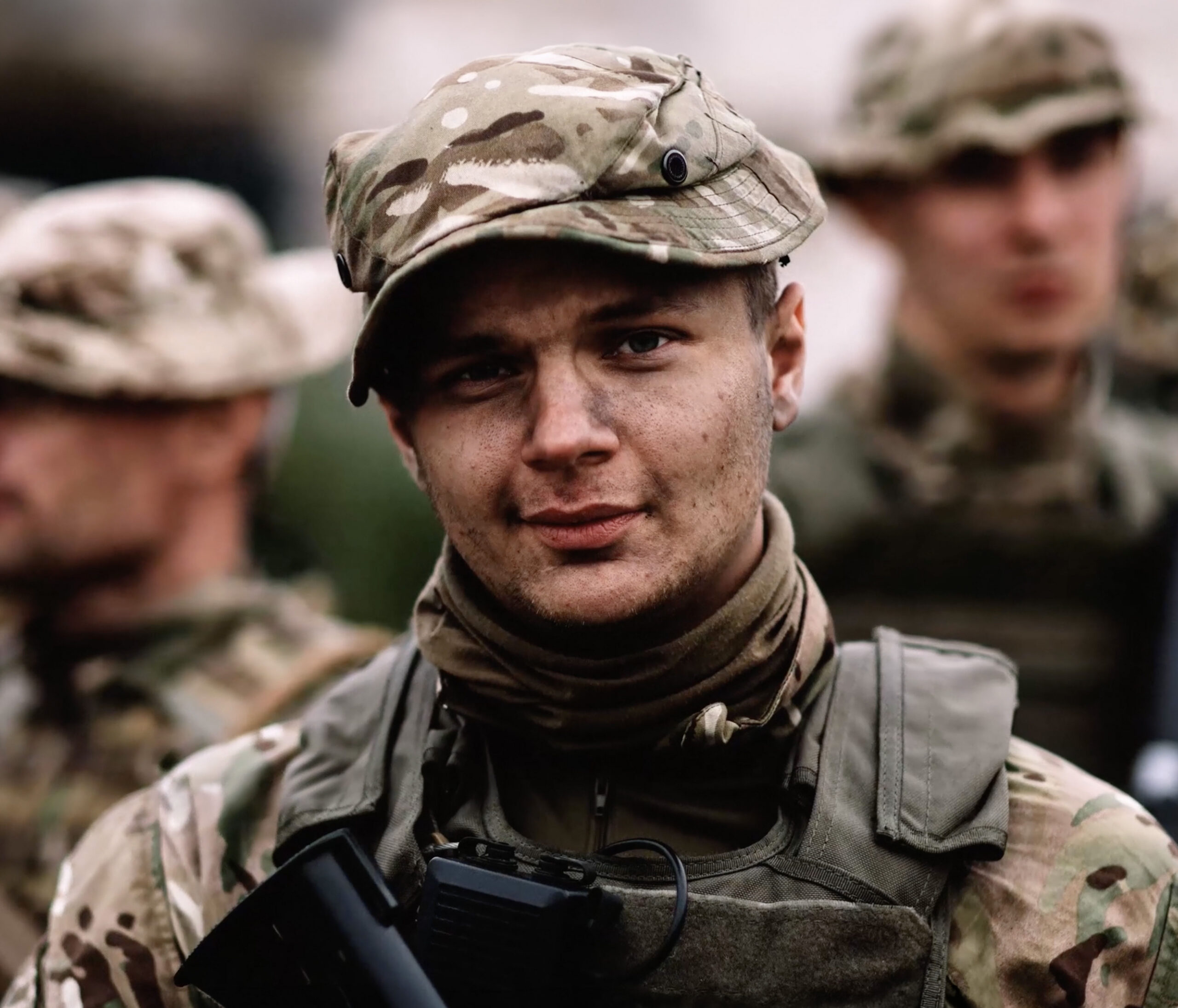 young man smiling with his army gear on